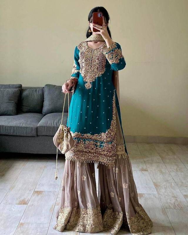 Faux Georgette sharara palazzo set features a top with real mirror and coding sequence embroidery. 
